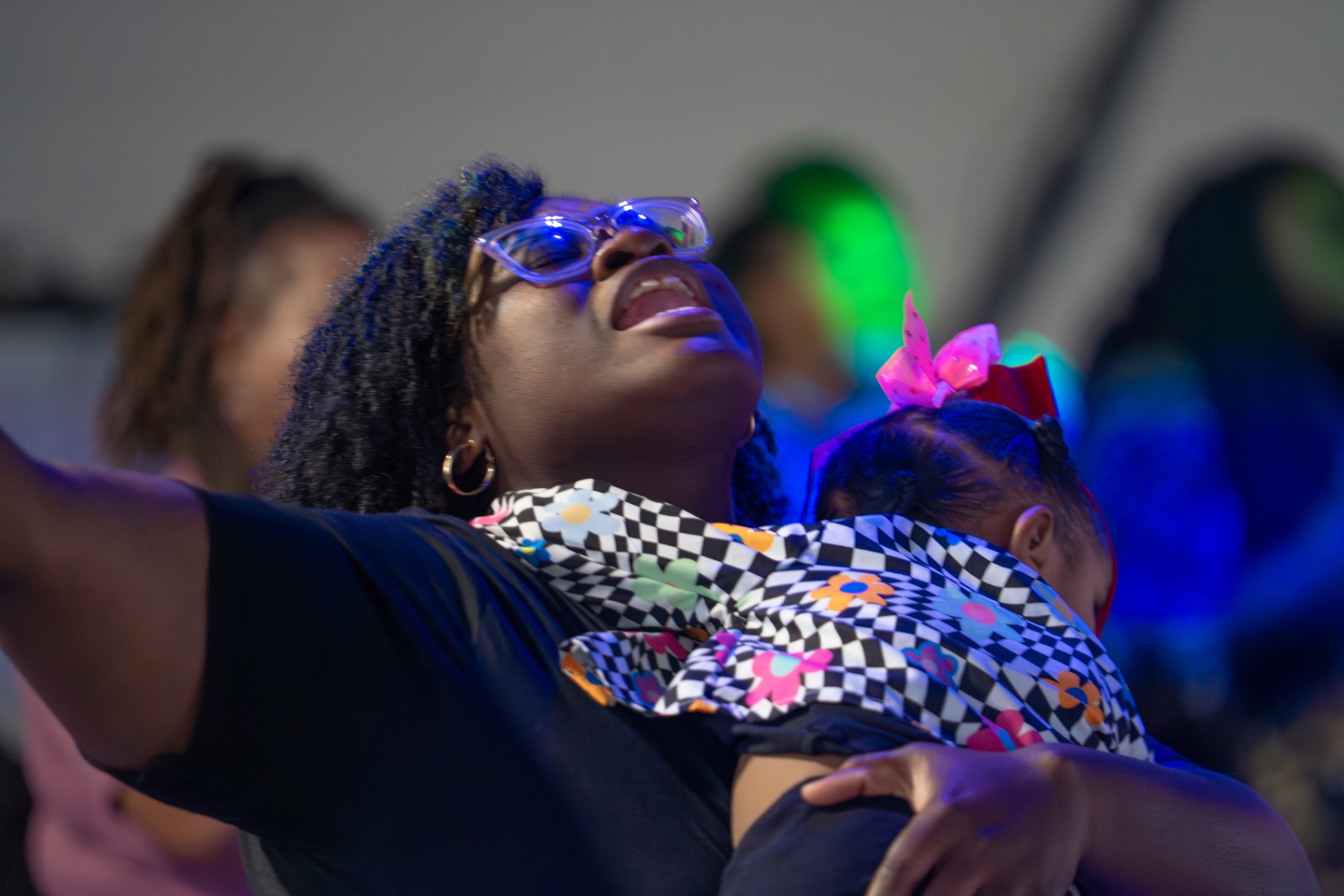 A mother holding her child during worship