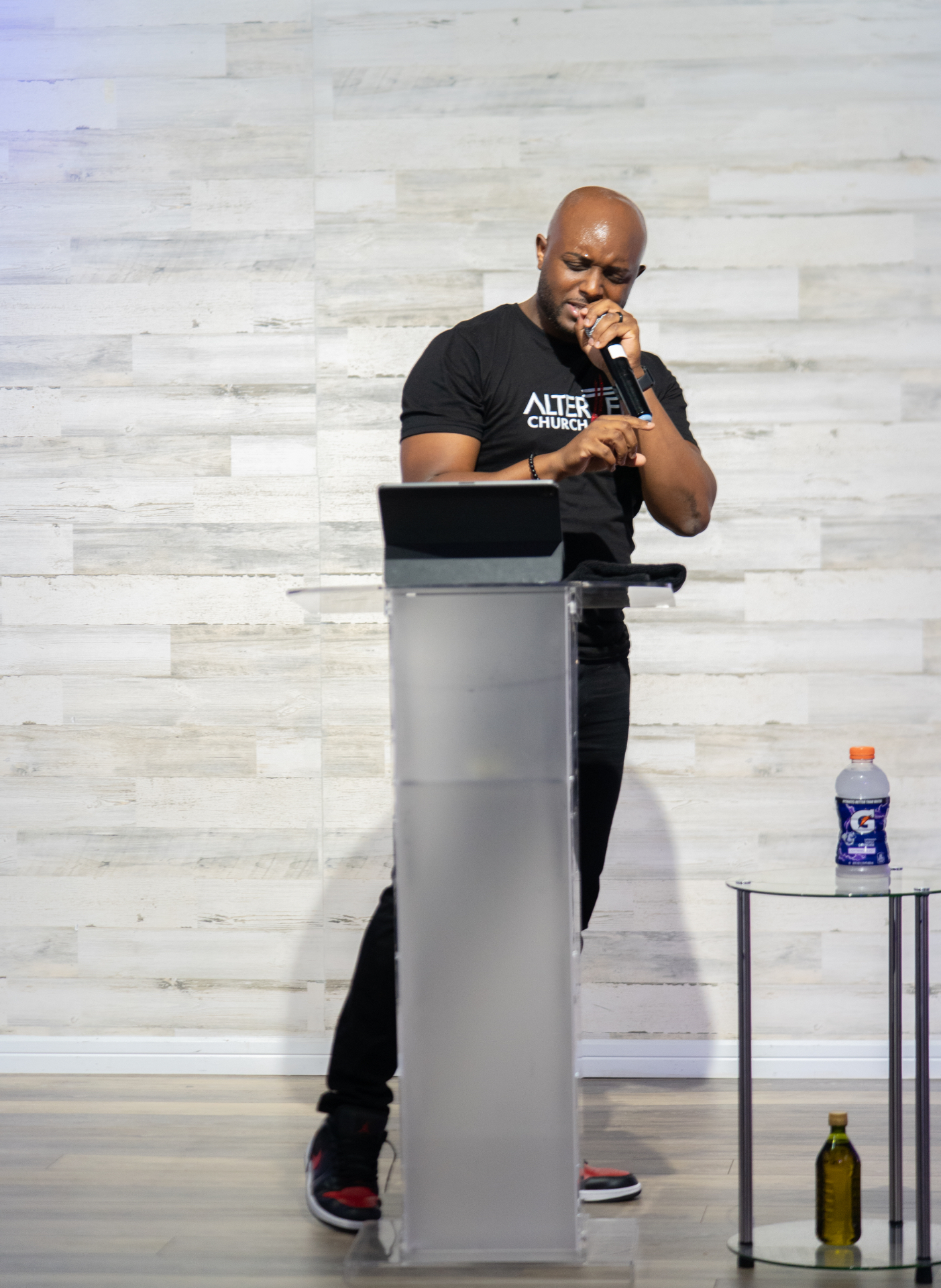 Pastor Fred preaching on stage